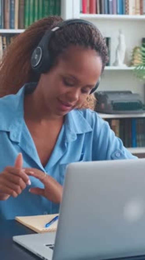 Woman With Headphones Studies At Computer At Home