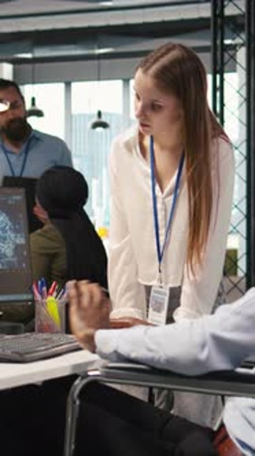 Vertical Video Young Engineer and Coworker with Paraplegia Using AI Doing Brainstorming