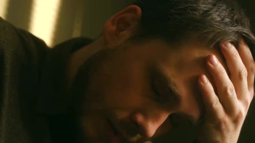 Sullen Young Adult with Hand on Head