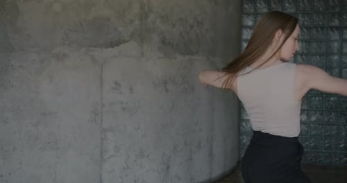 Portrait of Beautiful Young Woman in Stylish Clothing Dancing in Studio Alone