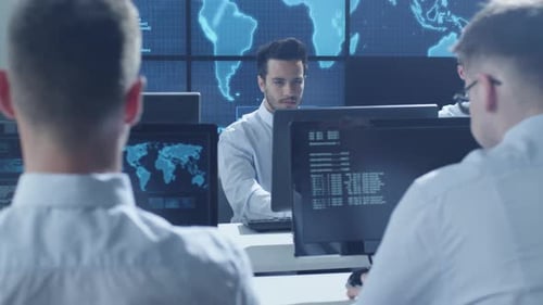 Team IT Security Professional Working in Bright Monitoring Room Filled with Displays