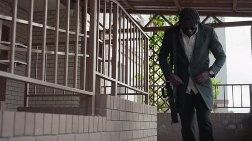 Well Dressed Man Walks Down Steps Outdoors
