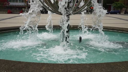 Water flows at high speed and pressure out of a water feature fountain from multiple points in a pub