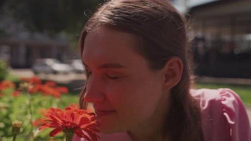 Candid Image of Woman in Park Capturing Peaceful Moment and Aroma Serene Young Woman in Pink