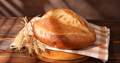 Fresh Bread Loaf and Wheat Stalk Still Life