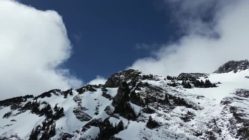 Snowy Mountain Peak, blue sky and clouds. British Columbia, Canada.