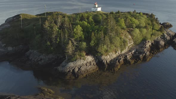 Up and to the right to reveal lighthouse and ferry from below tree line ...