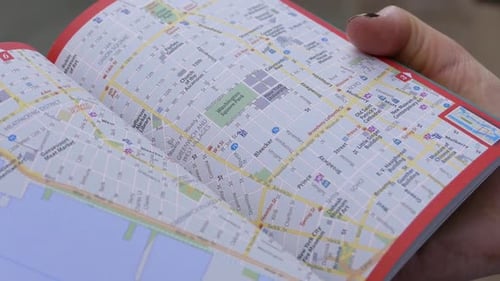 Close up of woman's hand looking at a New York City Map