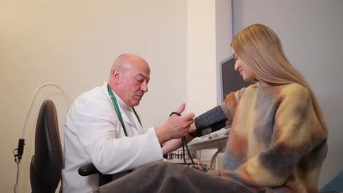 Doctor Checking Blood Pressure of Young Woman