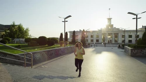 A Girl on a Morning Run in the Cityscape