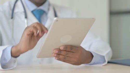 Doctor Using Tablet in Medical Office Setting