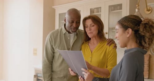 Senior Couple Looking at a Property with a Real estate agent