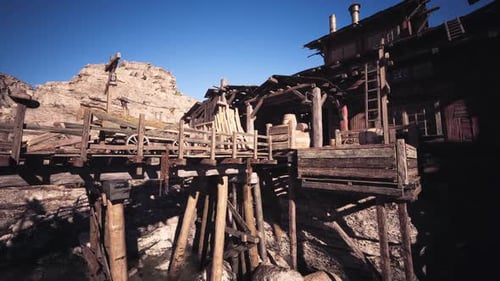 Old Wooden Dock Structure Near Rocky Terrain in Bright Daylight Setting