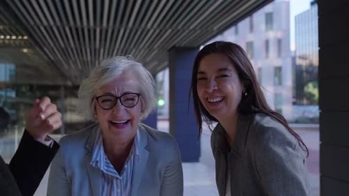Cheerful Group of Mature Businesswomen Gathering Outside Work Office Laughing Together