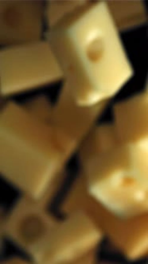 Super Slow Motion Pieces of Cheese Fall Onto a Cutting Board Filmed on a Highspeed Camera at 1000