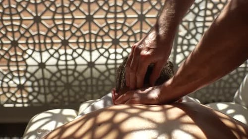 Detail Cropped Shot of Unrecognizable Masseur Male Hands Doing Therapeutic Neck Massage to Man Lying