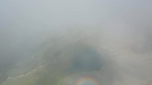 cinematic flight between clouds and mountains