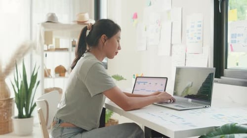 Asia girl IT development programmer typing on keyboard coding programming fixing data code.