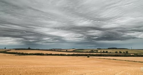 Stormy Moody Clouds Time Lapse Over Field In Summer