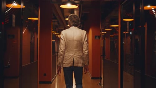 Businessman Walking in Office Corridor