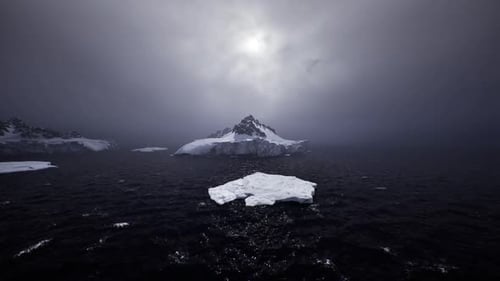 Unsettling Nocturnal Arctic View Featuring Faint Light and Fractured Ice Masses