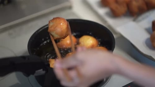 A woman making sata andagi