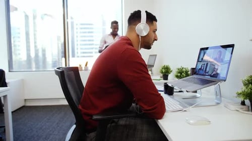 Businessman with Headphones Video Conferencing at Laptop 2529 Years