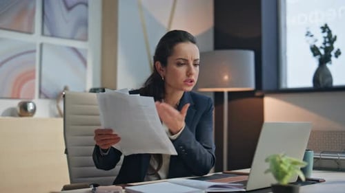Frustrated Woman Working at Computer in Modern Office