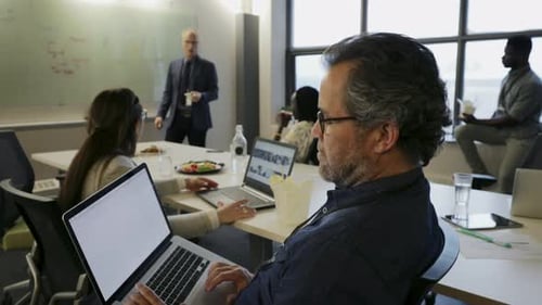 Businessman with Laptop Listening in Conference Room Meeting 2529 Years