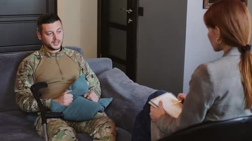 Man in Camo Talking with Therapist in Office