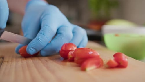 Chef Cuts Red Cherry Tomatoes On A Wooden Cutting Board