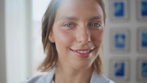 Smiling Young Woman in Indoor Daytime Setting