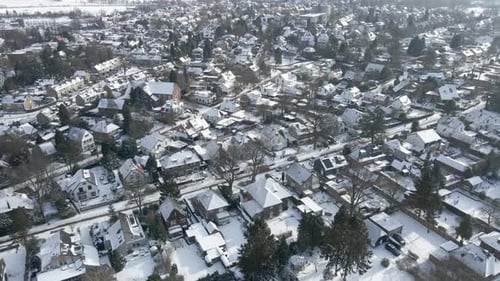 Flying over beautiful snow covered town in winter