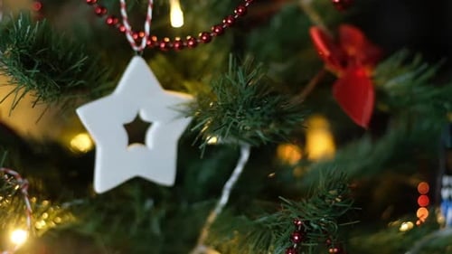 Happy New Year Christmas Tree Decorates with Red Glass Ball on Branch on Background Bokeh of Side