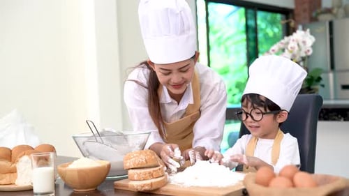 Professional pastry chef asian mom and son making bakery bread cake prepare delicious sweet food