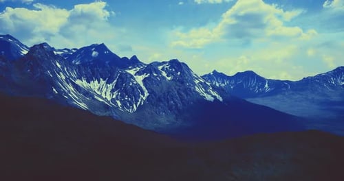 Majestic Mountain Range Under a Vivid Blue Sky During Golden Hour