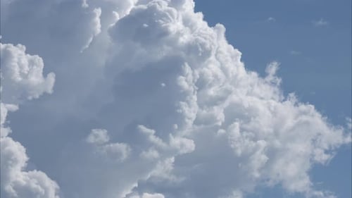 Aerial view of beautiful sky with clouds and sun on a summer day.