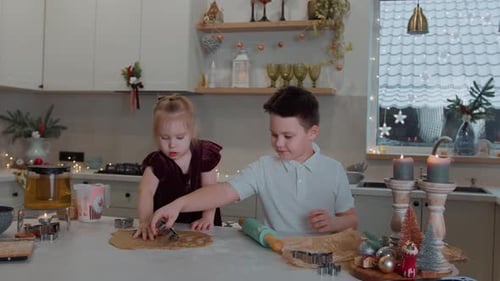 Festive Children Making Christmas Cookies in a Cozy Kitchen