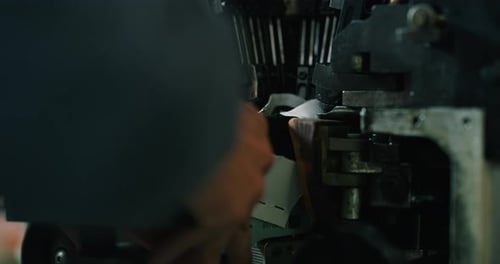 Macro of a shoemaker using a professional machine to bend the shoes and fix them according to the