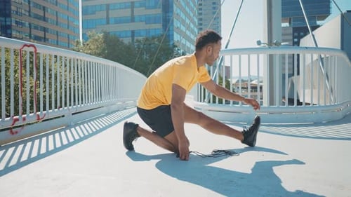 Young Man Stretching On Bridge In City