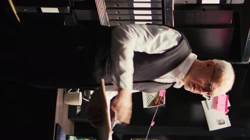 Senior Investigator Examines Evidence on Corkboard in Office