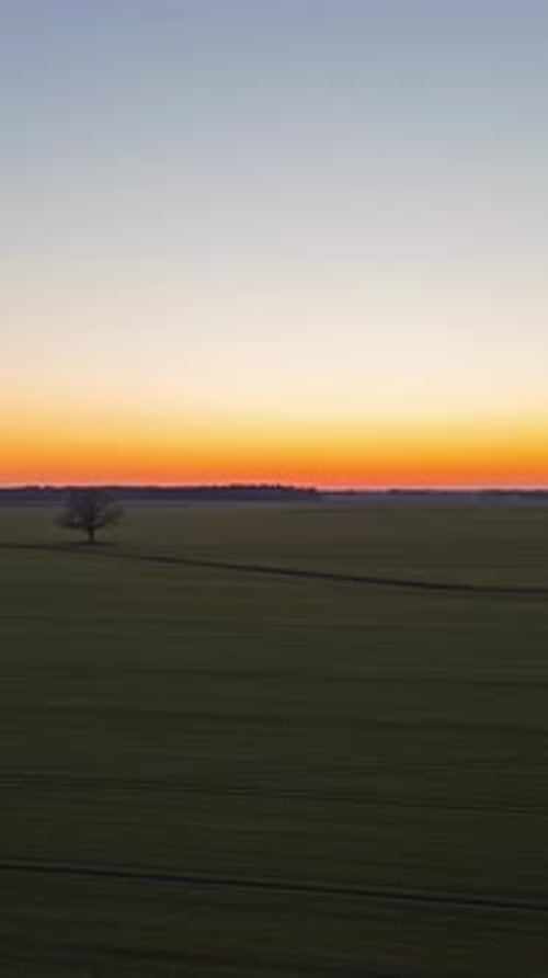 sunset over vast farmland