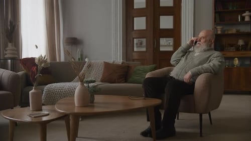 Senior Man Talking on Phone in Living Room