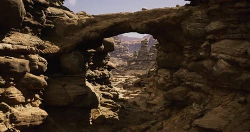 Vast Rocky Landscape Featuring a Natural Stone Arch Against Clear Skies