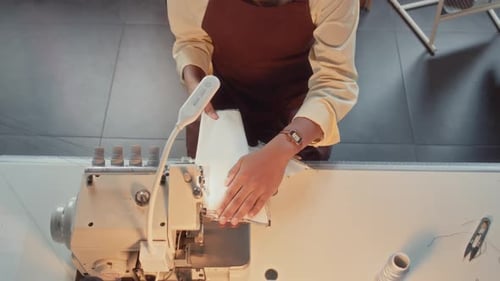 Seamstress Sews White Fabric on Sewing Machine