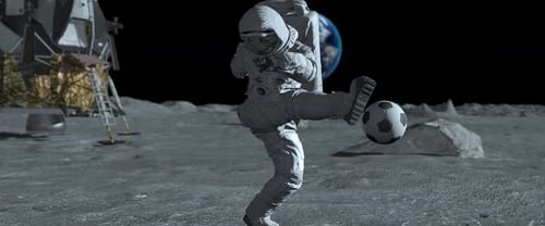 Astronaut on the moon play football. Slow motion.