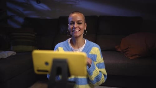 Woman Vlogging into Yellow Smartphone at Home