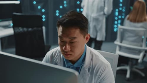 Data Center Asian Software Developer IT Technologist Using Desktop Computer Conducting Research