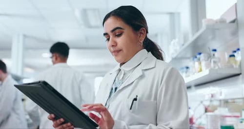 Scientist Woman Using Tablet in Modern Laboratory