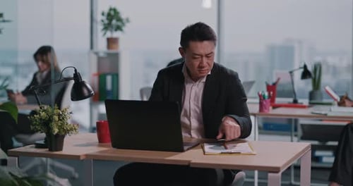 Chinese Adult Business Person Doing Corporate Task Ecommerce Financial Report in Creative Office